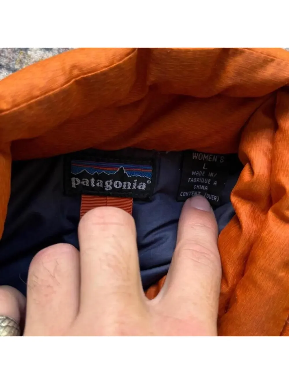 Vintage Patagonia orange puffer vest with stains